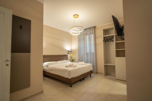 a bedroom with a white bed and a light fixture at Domus Nursia in Norcia