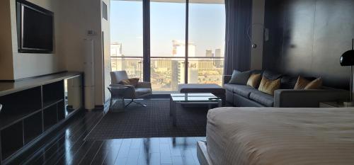 a hotel room with a bed and a couch at Palms Place Luxury 35th Floor Unit with Amazing Strip View in Las Vegas