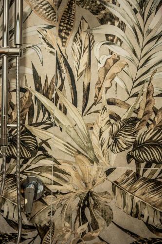 a bathroom with a mural of plants on the wall at Domus Nursia in Norcia
