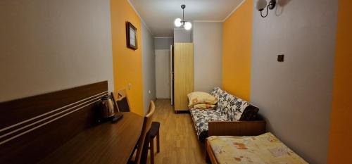 a living room with a couch and a table at Róża Wiatrów 2 Władysławowo in Władysławowo