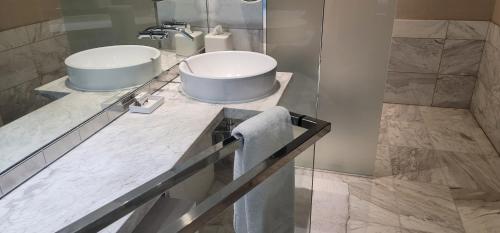 a bathroom with a sink and a mirror at Palms Place Luxury 35th Floor Unit with Amazing Strip View in Las Vegas