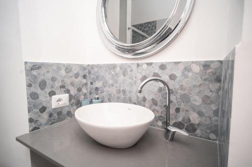 a bathroom with a white sink and a mirror at Esperia Maison B&b in Montesarchio