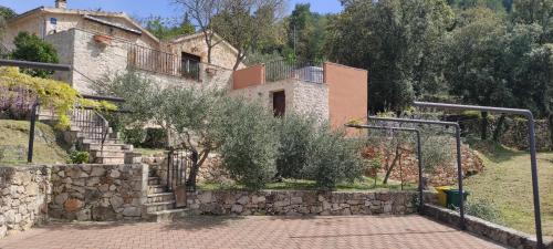 a house with a stone wall and a basketball hoop at Merlo House Dol Hvar in Stari Grad
