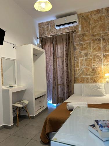 a bedroom with a bed and a vanity and a mirror at ERRIKA in Ermoupoli