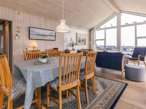 a dining room and living room with a table and chairs at 4 person holiday home in Sæby-By Traum in Sæby