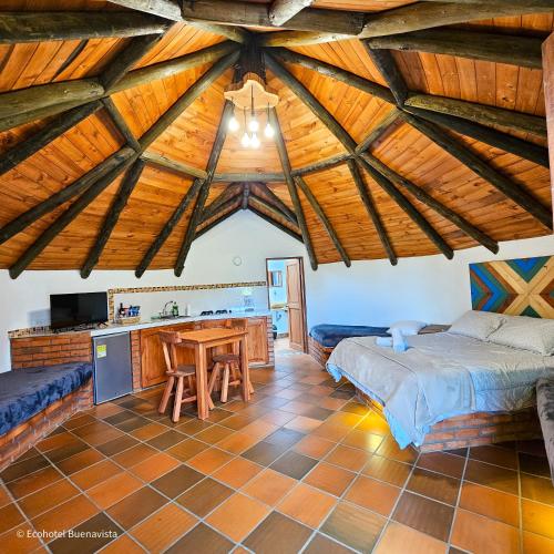 a bedroom with a bed and a wooden ceiling at Ecohotel Buenavista in Villa de Leyva