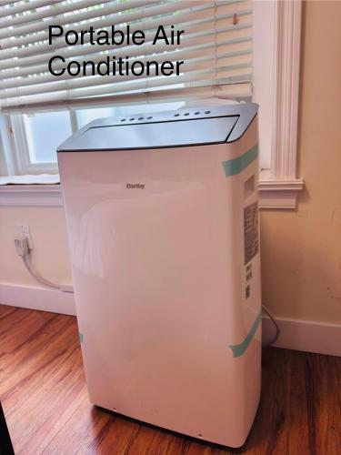 a cooler sitting on the floor next to a window at Cozy 2 beds Spacious rooms,Close to transit in Vancouver