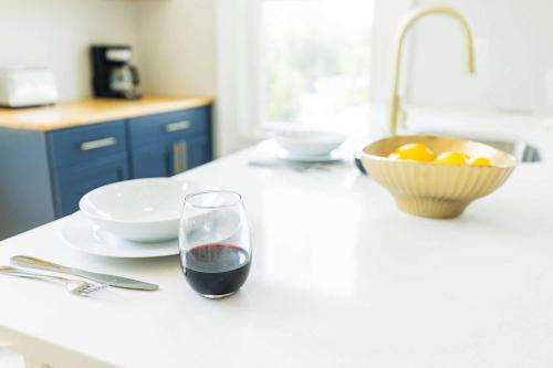 a glass of wine sitting on a kitchen counter at Jennifer's Spa-Like Modern & Chic Broadway Retreat in Providence