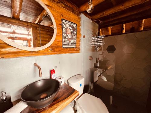 a bathroom with a sink and a toilet at Skyline Ecoliving Santa Elena in Santa Elena