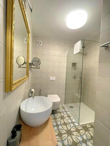 a bathroom with a sink and a toilet and a mirror at Botique Studio - Casa El Sueño II in Vodnjan