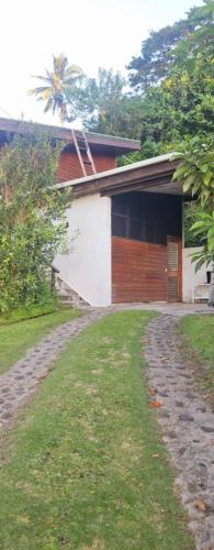 a house with a stone path next to a building at Ray's B&B in Matei