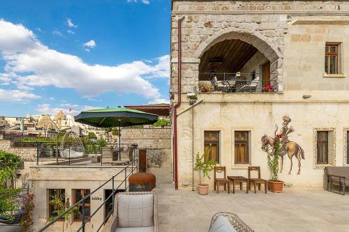 a building with a balcony with a horse on it at Onur Cave Cappadocia in Goreme