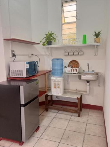 a small kitchen with a sink and a sink at Luna y Mar in Oaxaca City