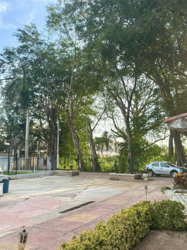 a car parked in a parking lot with trees at Quinta San Gabriel House in Turbaco