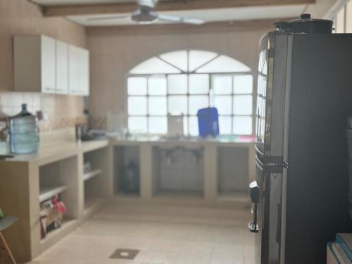 a kitchen with a refrigerator in the middle of a room at Quinta San Gabriel House in Turbaco