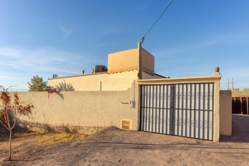 a gate on the side of a house at Amazing Home in Agafay With Pool & garden in Marrakech