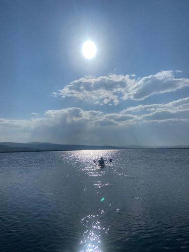 a person in the middle of a large body of water at Uros Titicaca Beluxia in Puno
