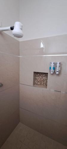 a bathroom with a shower with a light on it at Tres Palmas Departamentos in Los Mochis