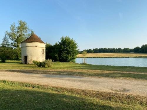 a building on the side of a body of water at Chateau de Russas, chambre d'hote in Saint-Adjutory
