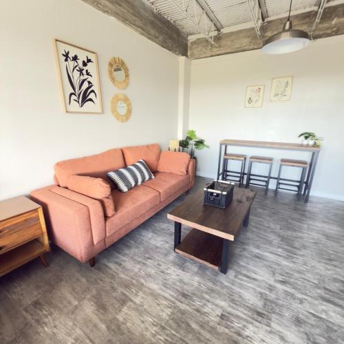 a living room with a couch and a table at Scenic Serenity, dtown, gym, free parking in Mobile