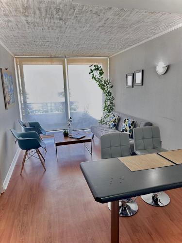 a living room with a couch and a table at Departamento Buena vista in Talca