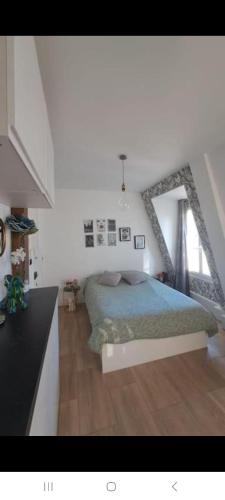 une chambre avec un lit et une grande fenêtre dans l'établissement Vue imprenable sur la Tour Eiffel, à Paris