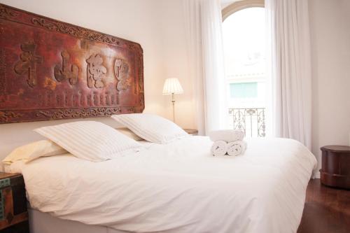a bedroom with a large bed with two towels on it at Malaga Center Flat Luxury in Málaga