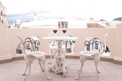 a table with two chairs and a table cloth at Malaga Center Flat Luxury in Málaga