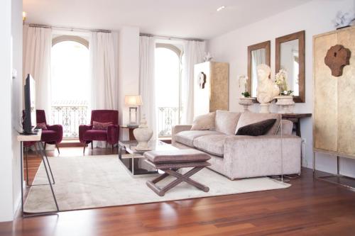 a living room with a couch and a table at Malaga Center Flat Luxury in M&aacute;laga