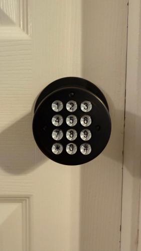 a light on a door with a bunch of buttons at K11 Private Room with Smart TV Near Everything in Orlando