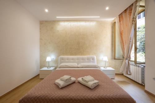 a bedroom with a large bed with two pillows on it at San Pietro Roma Suite in Rome