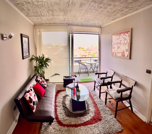 a living room with a couch and a table at Departamento Buena vista in Talca