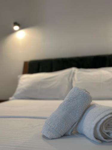 a pair of towels on a bed in a hotel room at Vila 44 in Sarandë