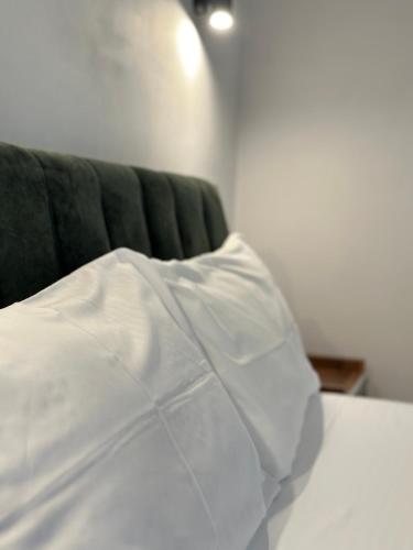 a white pillow sitting on top of a bed at Vila 44 in Sarandë