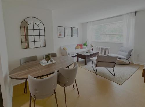 a living room with a table and chairs at Cozy Upper Beaches Apartment in Toronto