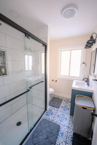 a bathroom with a shower and a toilet and a sink at Oscawana Lake Escape in Putnam Valley