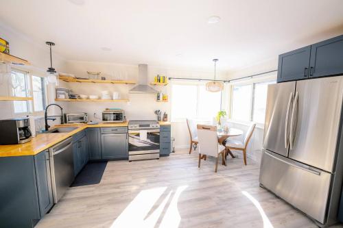 a kitchen with a stainless steel refrigerator and a table at Oscawana Lake Escape in Putnam Valley