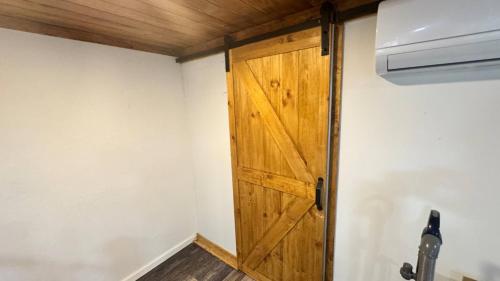 a closet with a wooden door in a room at Oscawana Lake Escape in Putnam Valley