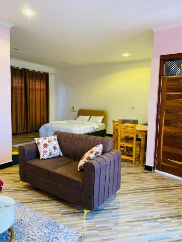 a living room with a couch and a bed at One bedroom Dodoma in Dodoma