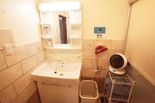 a small bathroom with a sink and a mirror at 2F - Vacation STAY 41649v in Okinawa City