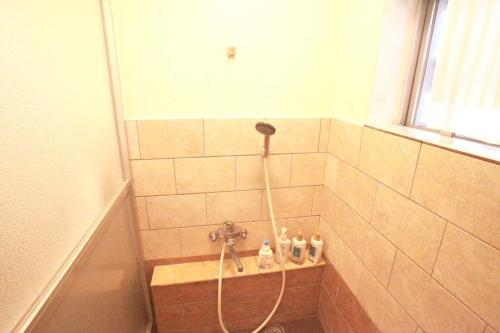 a shower with a hose in a bathroom at 2F - Vacation STAY 41649v in Okinawa City