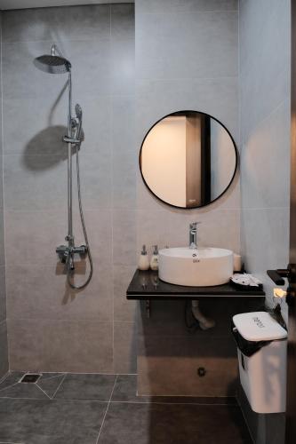 a bathroom with a sink and a mirror at Homestay SkyLight in Dong Hoi