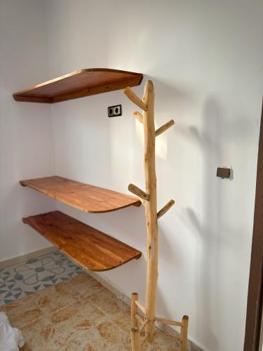 a shelf made out of logs on a wall at Eco Bay Surf Camp in Aourir