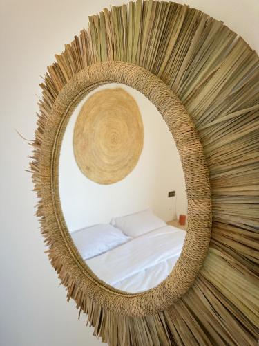 a large mirror with a bed in a room at Eco Bay Surf Camp in Aourir