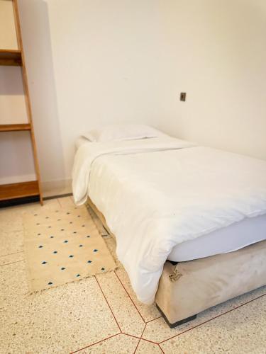 a bedroom with two beds and a rug at Eco Bay Surf Camp in Aourir