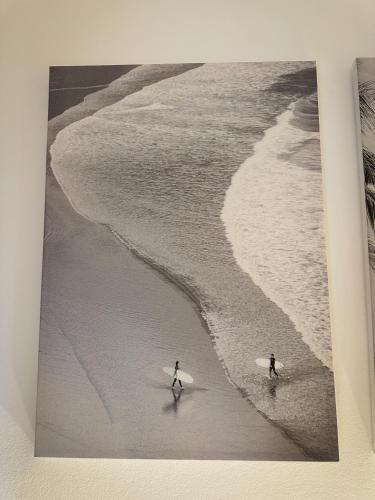 two surfers walking on the beach with their surfboards at Eco Bay Surf Camp in Aourir