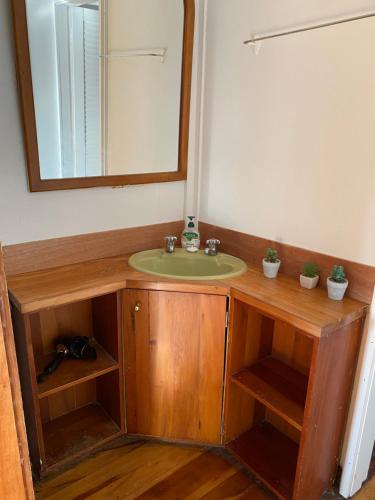 a bathroom with a sink and a mirror at Waitomo Farmstay Cottage 1 - Kauri Cottage in Waitomo Caves
