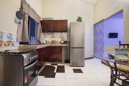 a kitchen with a stainless steel refrigerator and a table at 876 Oasis in Retreat