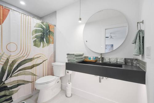 a bathroom with a white toilet and a mirror at Stylish Austin Escape 4BR, 2BA, Minutes from Domain, Q2 Stadium in Austin