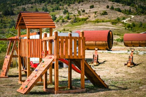 a wooden playground with a slide and a wooden tower at Transylvania Undiscovered 